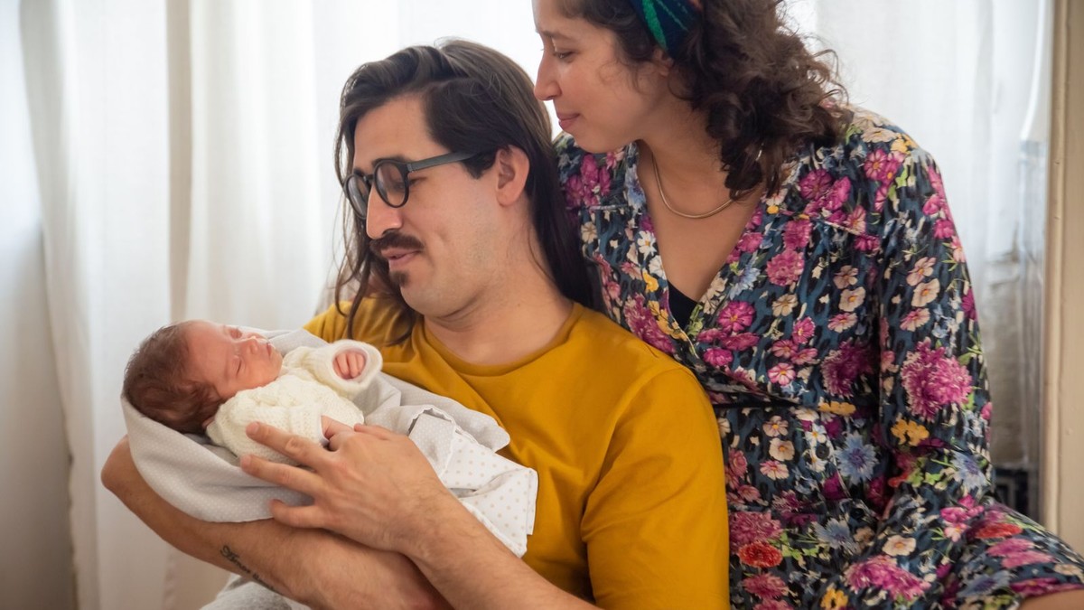 pais recém-chegados em casa com o bebê recém-nascido, momento de conexão em família